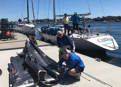 Crew prepping outfit of sails for CHARIAD
