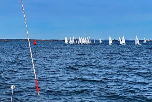 CHARIAD sailing in Marblehead Harbor with view of Lasers racing