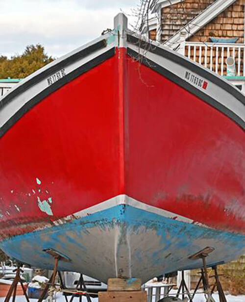 Sailor's winter view of boat with red hull out of the water